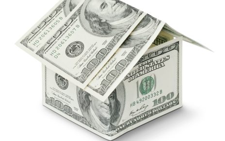 A house made of folded hundred dollar bills representing finance and investment concepts